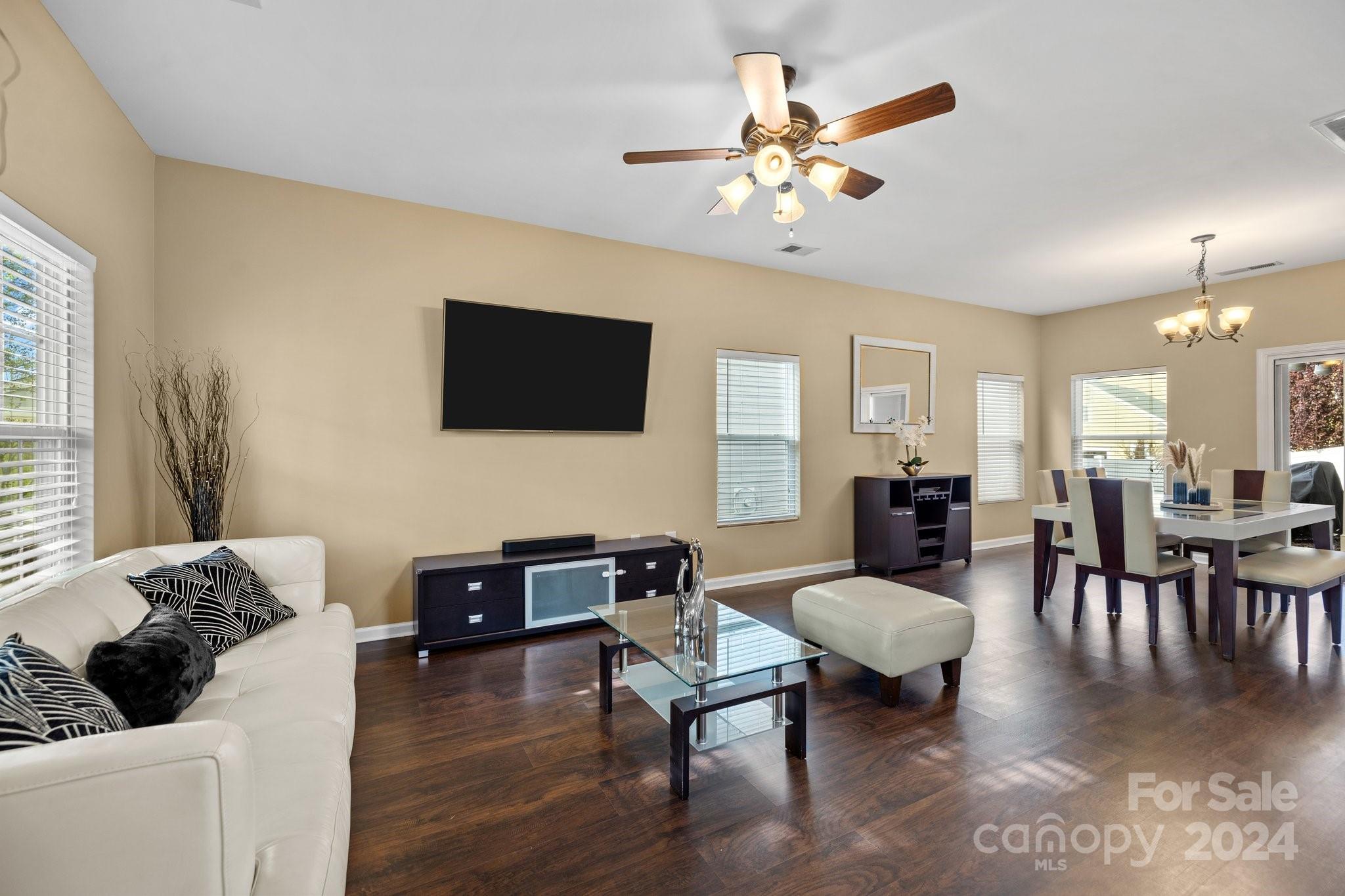 10231 Enniscrone Road Pineville, NC 28134 - Photo 6 of 44 a living room with furniture and a flat screen tv