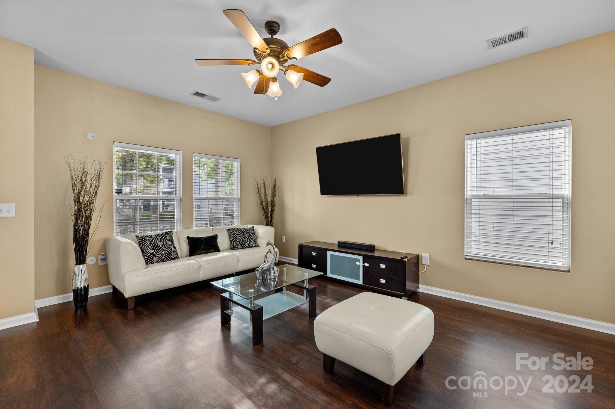 10231 Enniscrone Road Pineville, NC 28134 - Photo 7 of 44 a living room with furniture and a flat screen tv