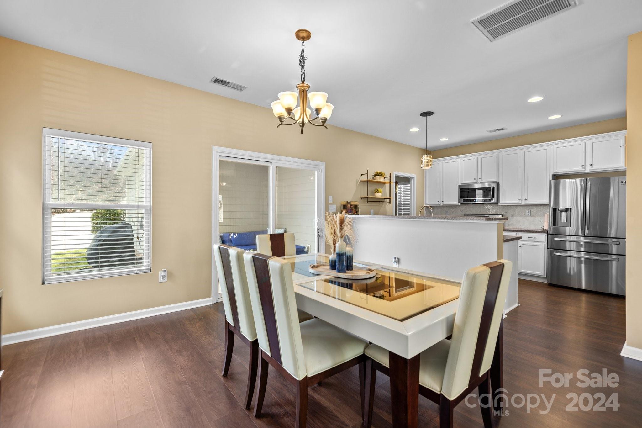 10231 Enniscrone Road Pineville, NC 28134 - Photo 9 of 44 a view of a dining room with furniture window and wooden floor
