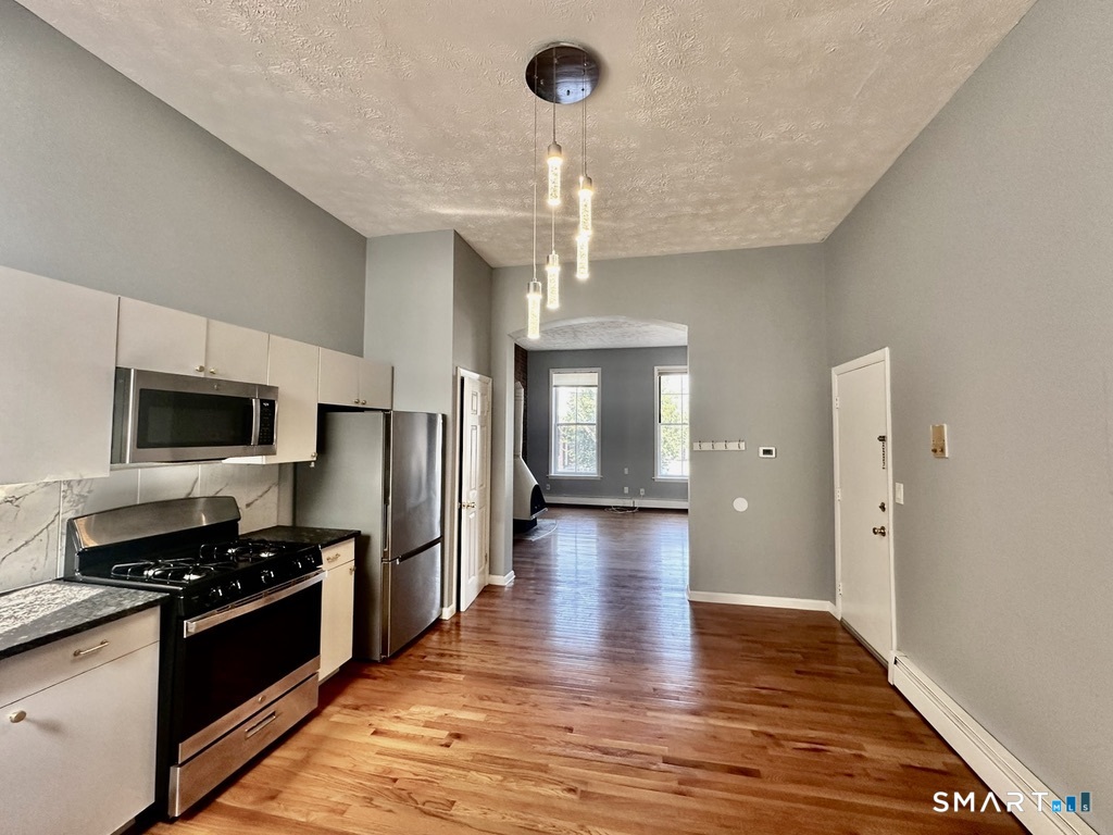 46 Warren Street New Haven, CT 06511 - Photo 7 of 10 a kitchen with stainless steel appliances kitchen island granite countertop a refrigerator and a stove top oven