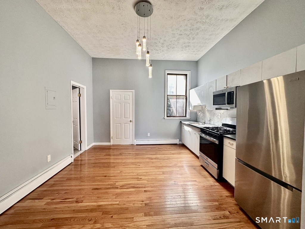 46 Warren Street New Haven, CT 06511 - Photo 8 of 10 a large kitchen with kitchen island a counter top space stainless steel appliances and cabinets