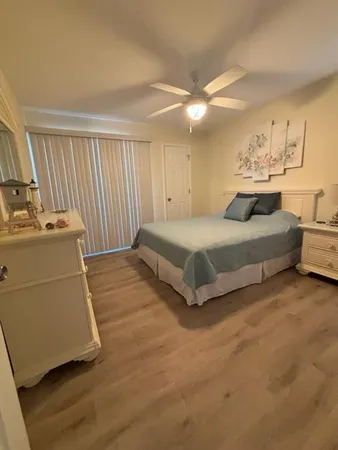 a spacious bedroom with a bed and a cabinets