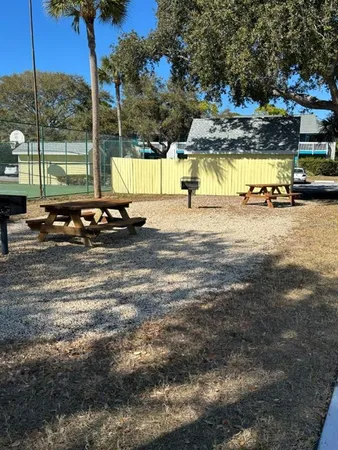 a view of a swimming pool with a bench and lawn chairs