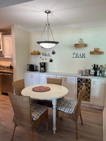 a kitchen with stainless steel appliances a refrigerator a sink a stove and white cabinets