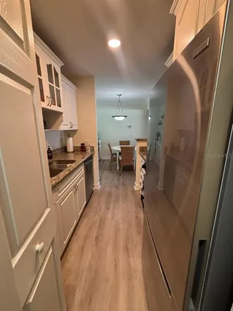 a kitchen with stainless steel appliances granite countertop a stove and a refrigerator