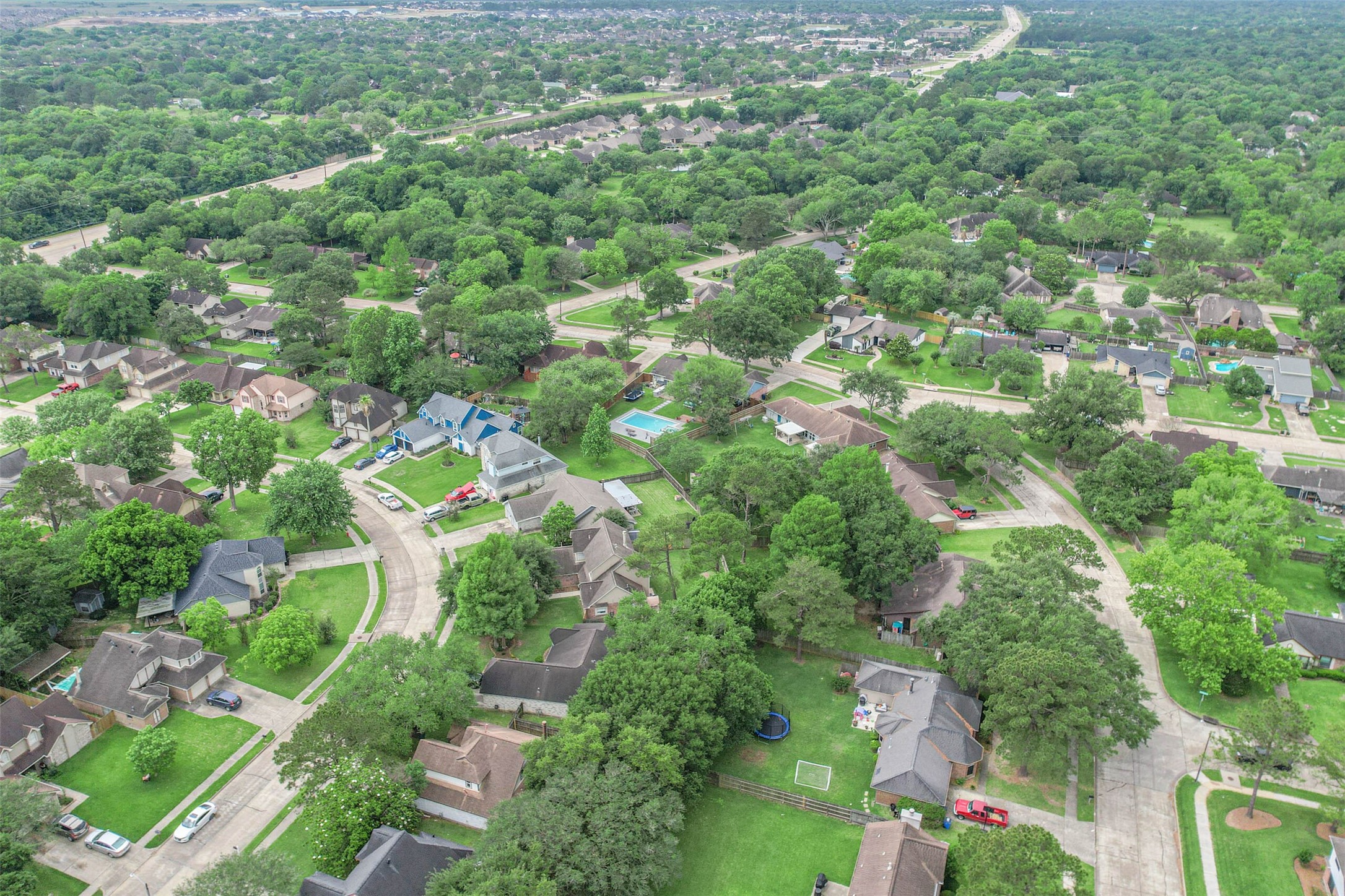 718 Regency Court Friendswood, TX 77546 - Photo 21 of 21 Aerial view of the street where this home is located. Regency ct is the street that starts in the bottom left of this photo and continues until it meets with 528 at the top of the photo. Nearest intersection is 518 and 528 with HEB shopping center nearby.