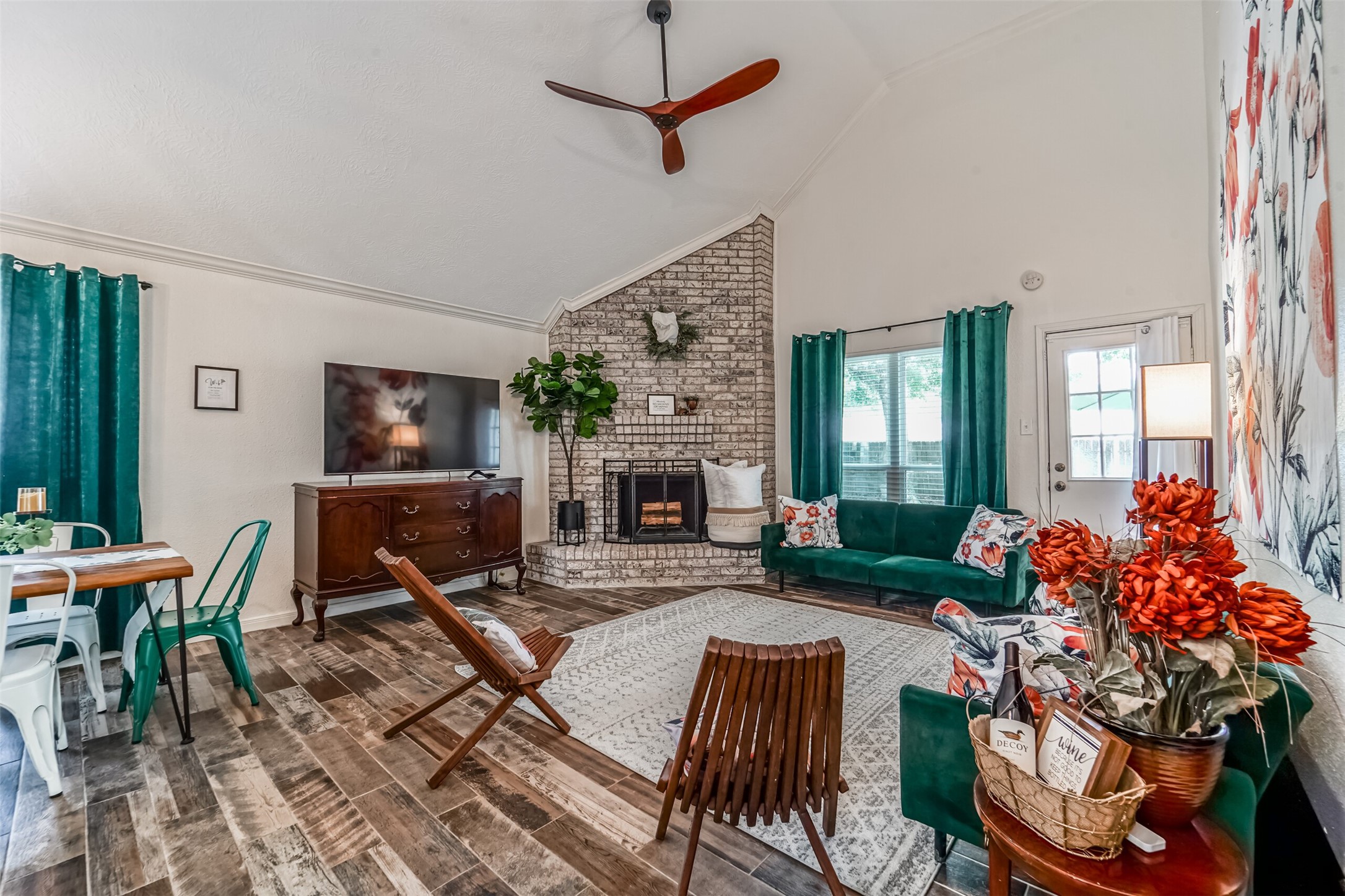718 Regency Court Friendswood, TX 77546 - Photo 3 of 21 Upon entry, you are greeted by soaring 2 story ceiling, wood-look plank tile flooring, and cozy furnishings. Wood burning brick fireplace centers the space. Fast wi-fi, and large smart TV.