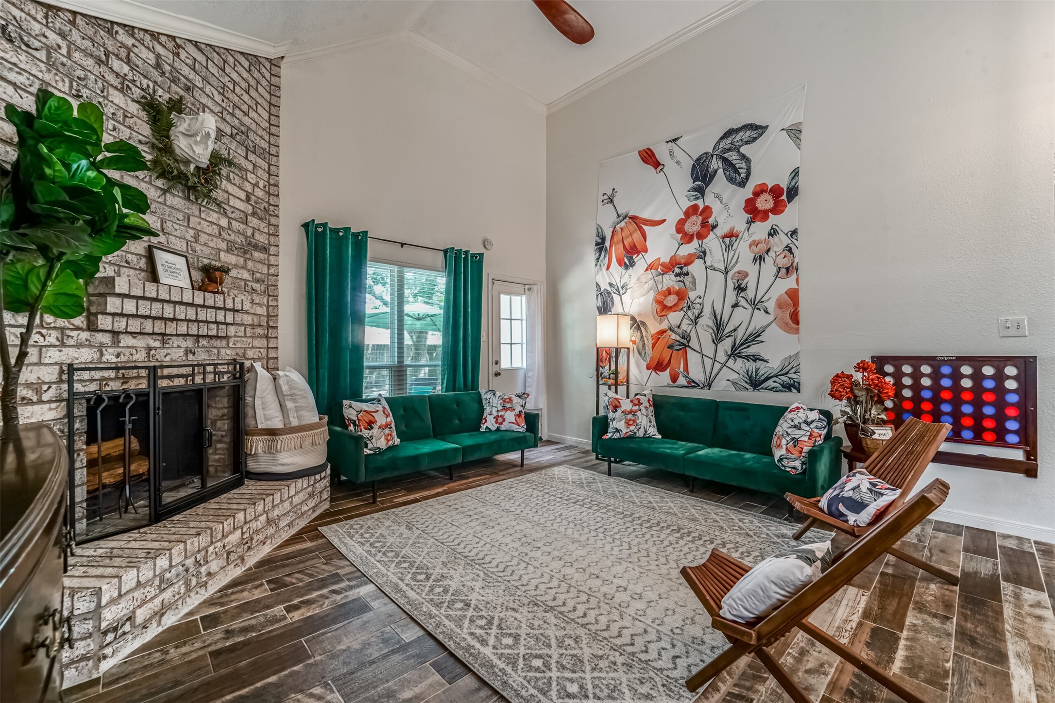 718 Regency Court Friendswood, TX 77546 - Photo 4 of 21 Kids adore our resident T-Rex above the fireplace, and a match of connect four in this space! The door in the back of this photo leads to a private backyard with small patio.