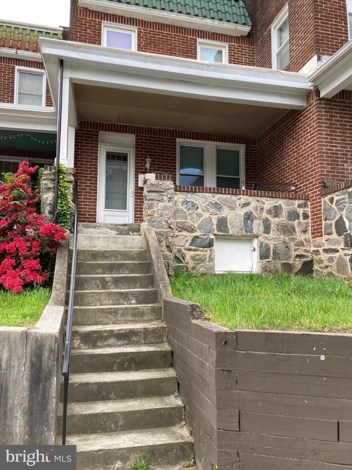 a front view of house with outdoor seating and yard