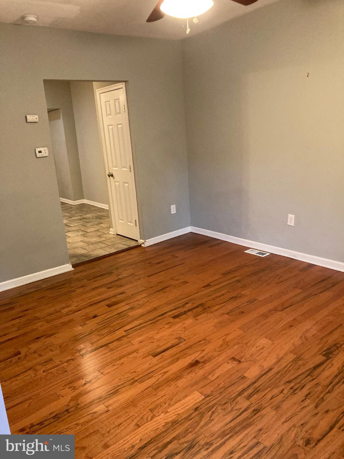 1213 West Old Cold Spring Lane Baltimore, MD 21211 - Photo 2 of 15 a view of an empty room with wooden floor