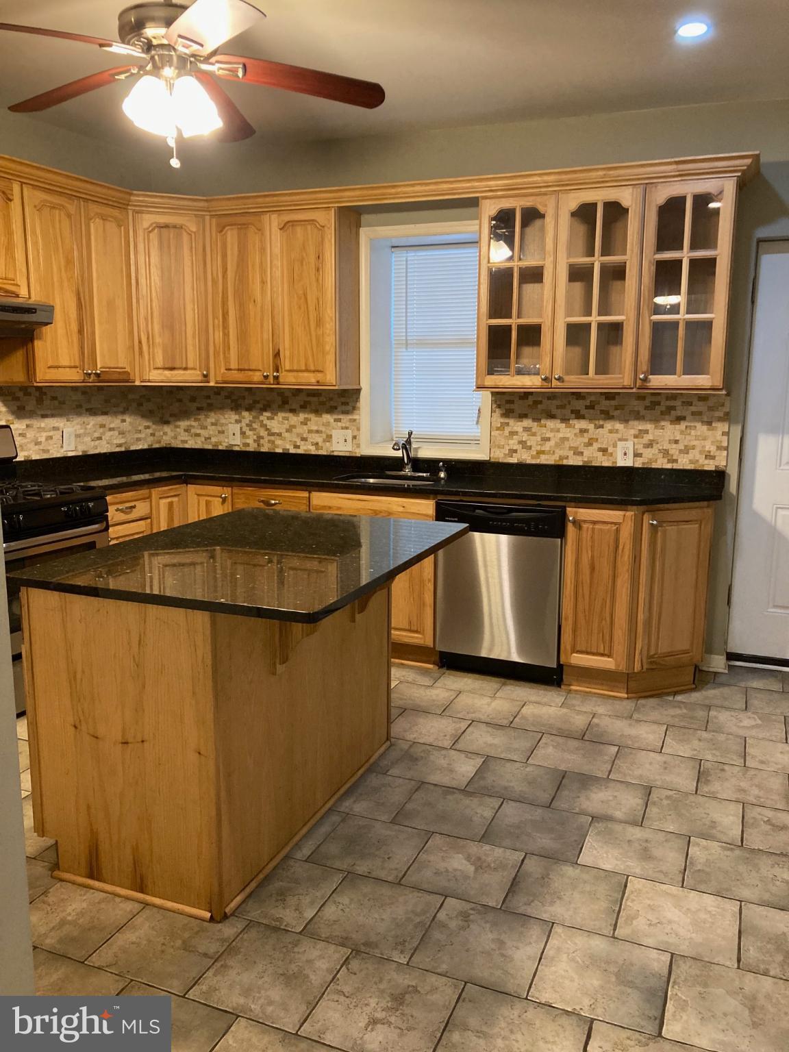1213 West Old Cold Spring Lane Baltimore, MD 21211 - Photo 3 of 15 a view of a kitchen with granite countertop a sink and a stove