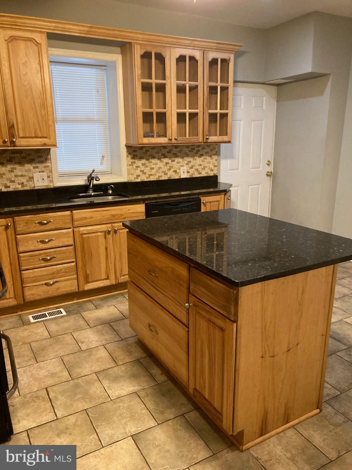 1213 West Old Cold Spring Lane Baltimore, MD 21211 - Photo 4 of 15 a kitchen with granite countertop a sink and a stove
