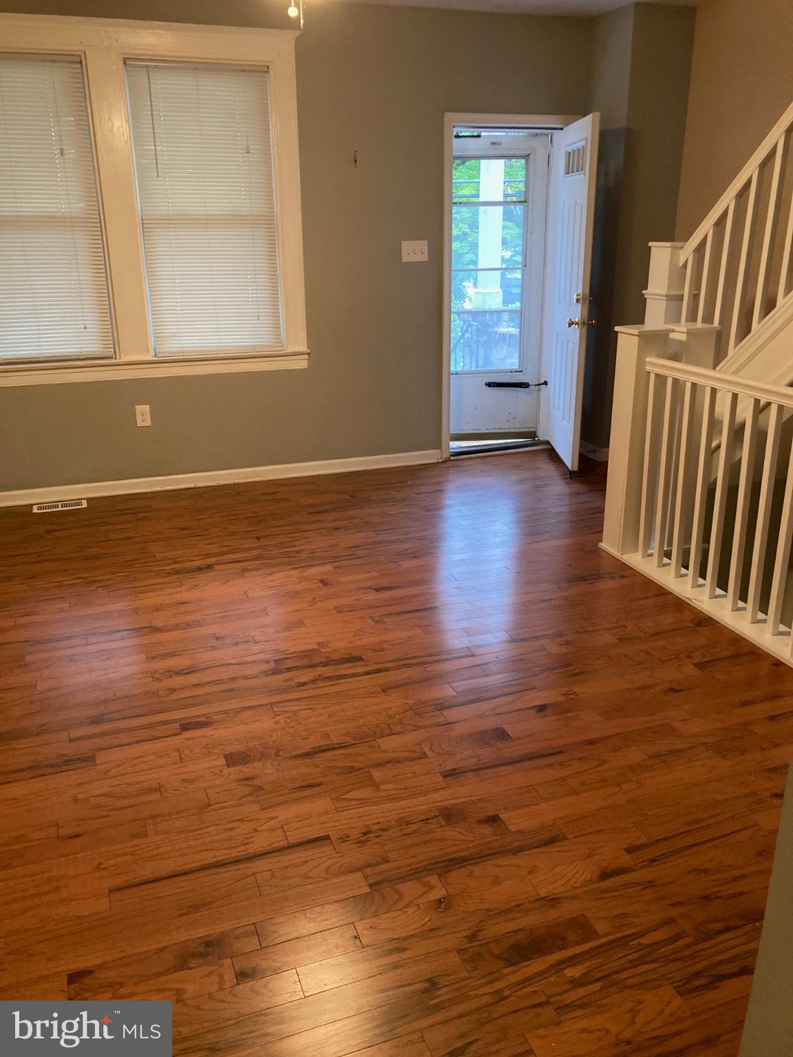 1213 West Old Cold Spring Lane Baltimore, MD 21211 - Photo 7 of 15 a view of an empty room with wooden floor and a window