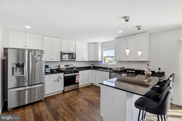 a kitchen with a refrigerator a stove a sink and a microwave