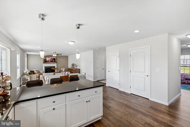 a kitchen with sink refrigerator and large window