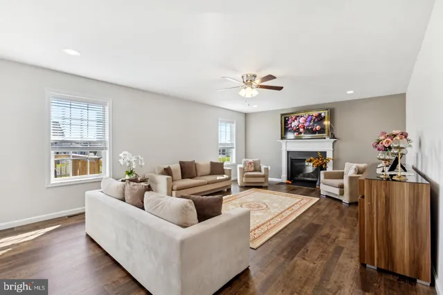 a living room with furniture fireplace and a window