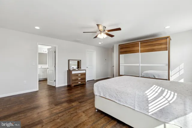 a bedroom with a large bed and a window