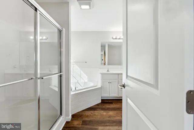 a bathroom with a sink and a mirror with bathtub