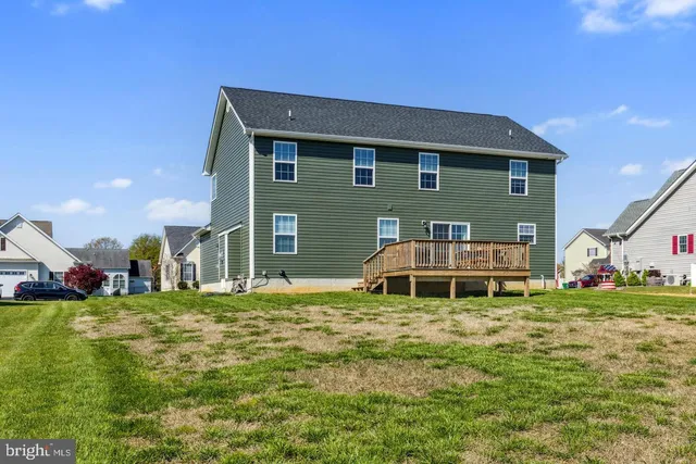 a view of a house with a yard and sitting area