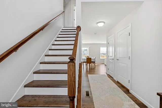 a view of entryway and hall with wooden floor