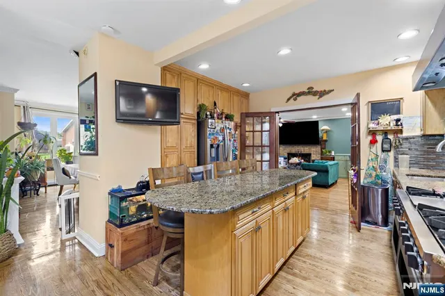 a kitchen with stainless steel appliances microwave stove refrigerator and wooden floor