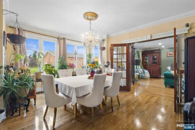 a view of a dining room with furniture wooden floor and chandelier