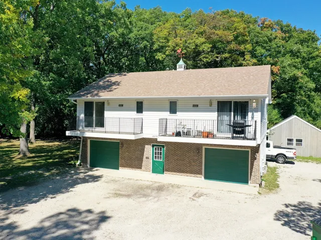 a view of house with outdoor space and sitting area