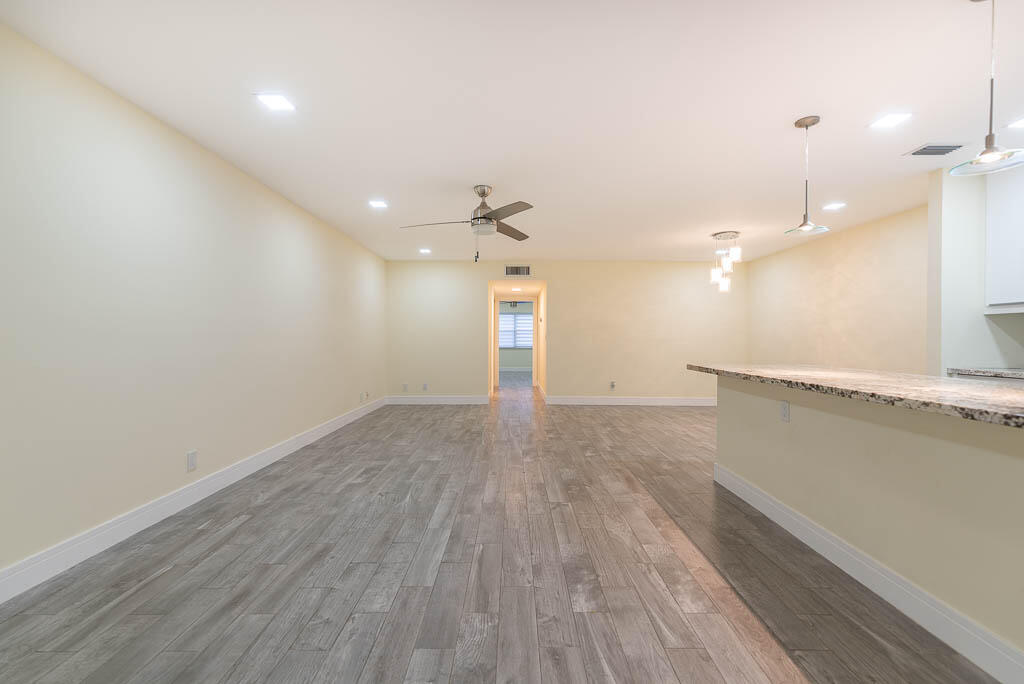 14250 Nesting Way, Unit B Delray Beach, FL 33484 - Photo 18 of 45 a view of a room with wooden floor and window