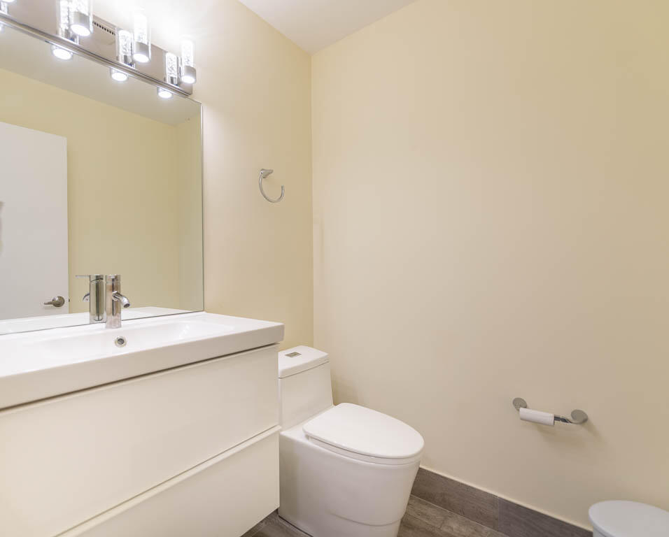 14250 Nesting Way, Unit B Delray Beach, FL 33484 - Photo 19 of 45 a bathroom with a sink a toilet and a mirror