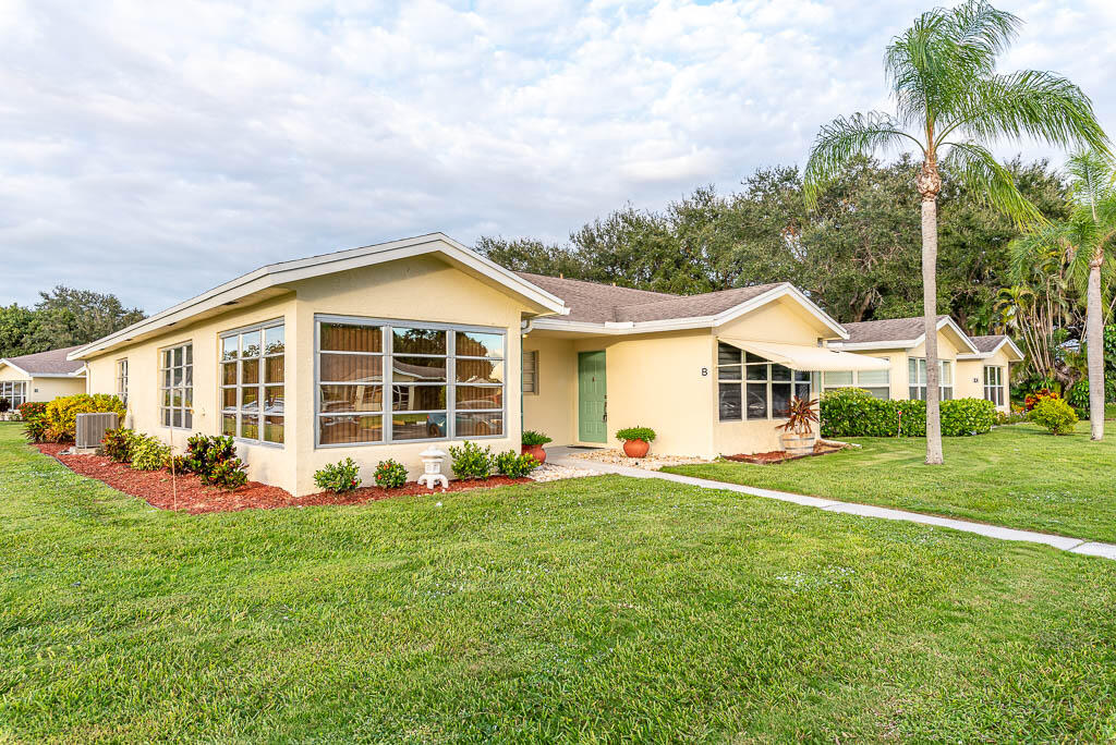 14250 Nesting Way, Unit B Delray Beach, FL 33484 - Photo 2 of 45 a view of a house with a big yard and potted plants