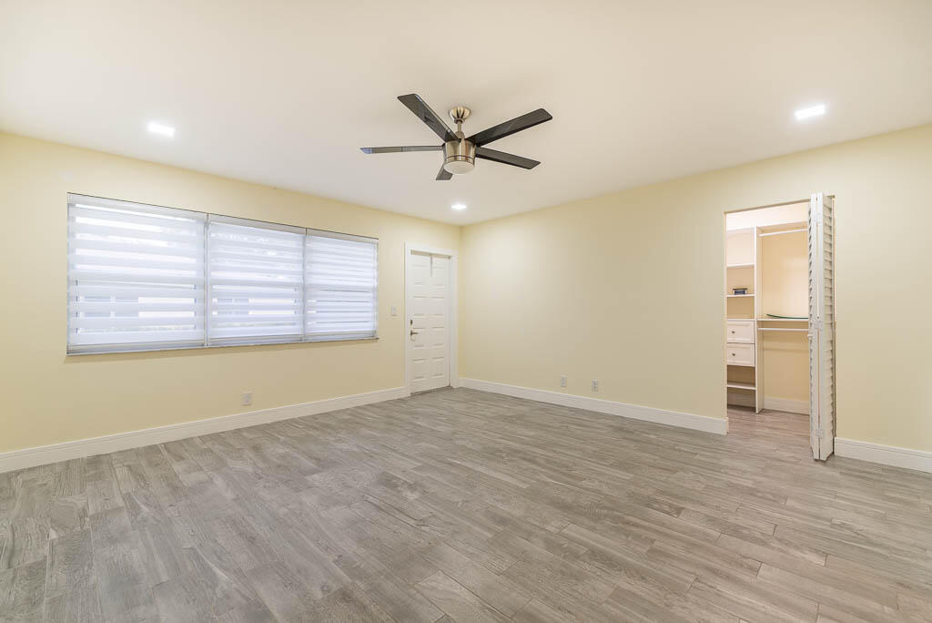 14250 Nesting Way, Unit B Delray Beach, FL 33484 - Photo 22 of 45 wooden floor in an empty room with a window