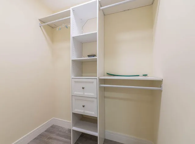 an empty room with fan and windows