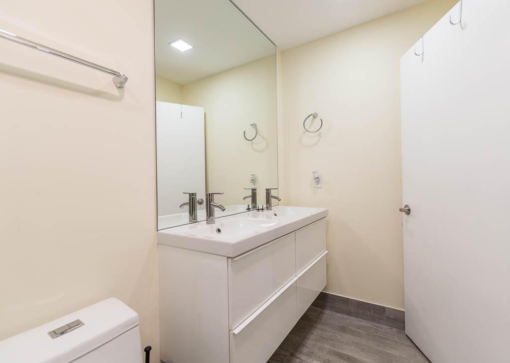 14250 Nesting Way, Unit B Delray Beach, FL 33484 - Photo 28 of 45 a bathroom with a sink a toilet and a mirror
