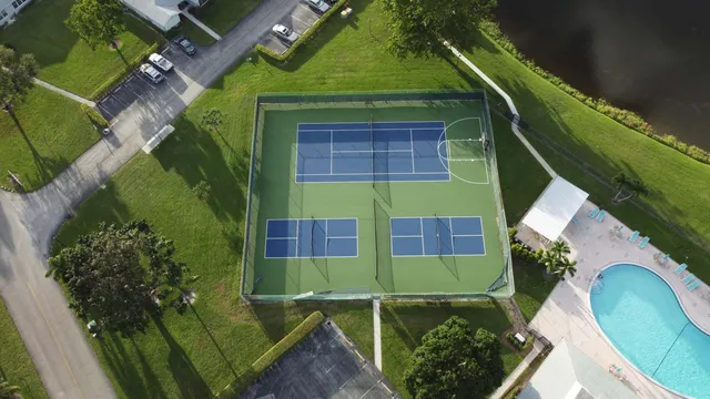 a view of a patio with a table chairs and a floor to ceiling window
