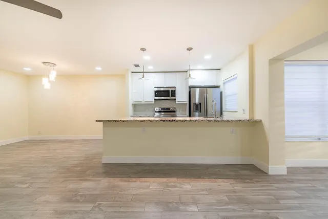 a view of kitchen with microwave and stove
