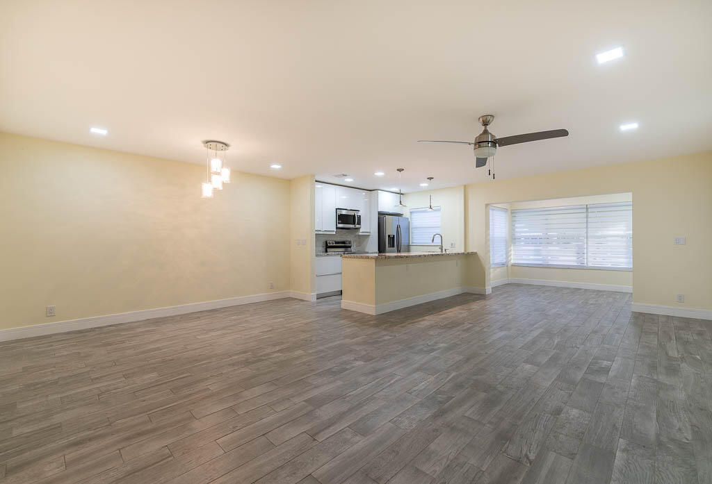 14250 Nesting Way, Unit B Delray Beach, FL 33484 - Photo 6 of 45 a view of a kitchen with a sink and a refrigerator