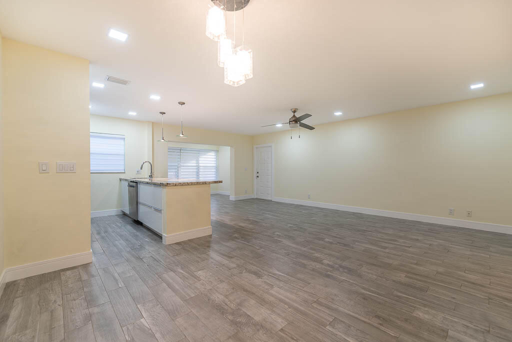 14250 Nesting Way, Unit B Delray Beach, FL 33484 - Photo 8 of 45 an empty room with wooden floor and windows