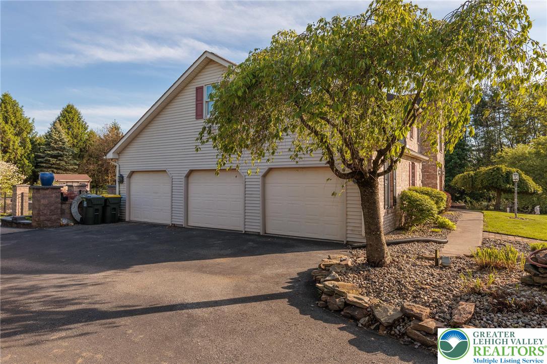 2170 Clearview Road Coplay, PA 18037 - Photo 5 of 75 This residence features a multi-car garage and a paved driveway, surrounded by mature landscaping.