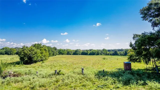a view of a golf club with a backyard of a house