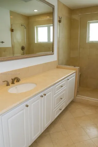 a spacious bathroom with a sink and a mirror