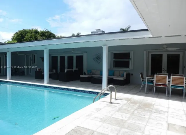 a view of a patio with table and chairs with wooden fence