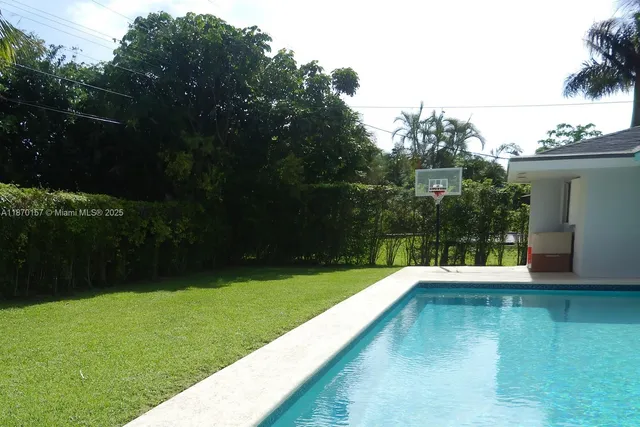 a view of a swimming pool with a yard
