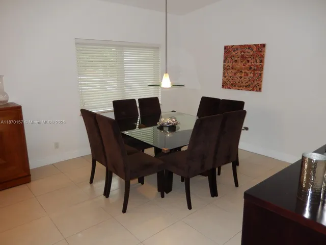 a view of a dining room with furniture and window