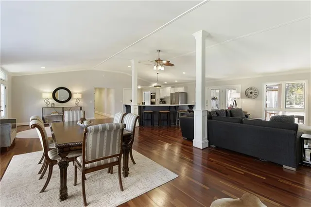 a dining room with furniture and wooden floor