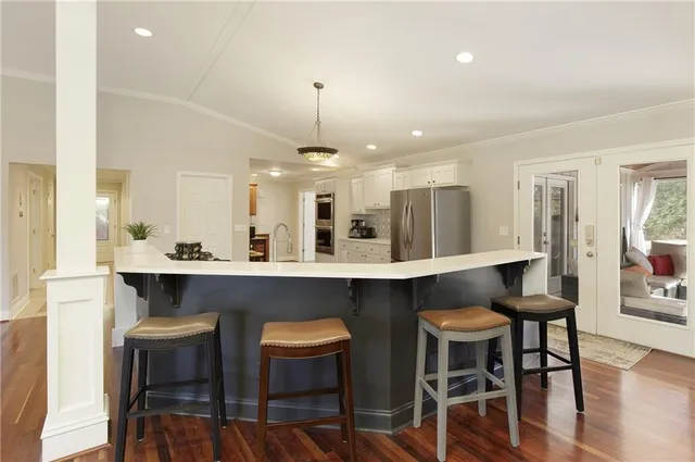 a large kitchen with a table and chairs in it