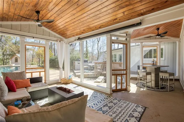 a living room with furniture and a floor to ceiling window