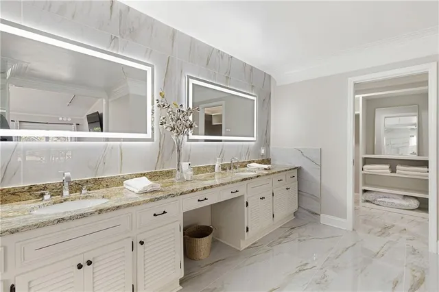 a bathroom with a granite countertop sink mirror and bathtub