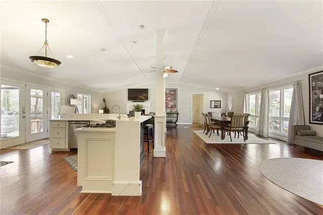 a living room with furniture dining table and wooden floor