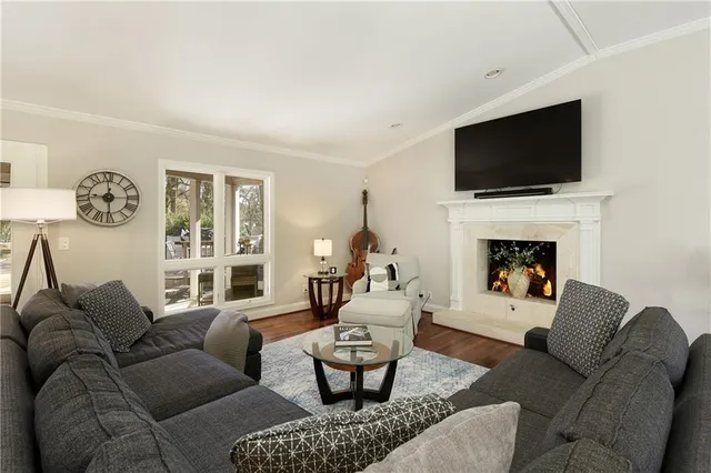 a living room with furniture fireplace and a flat screen tv
