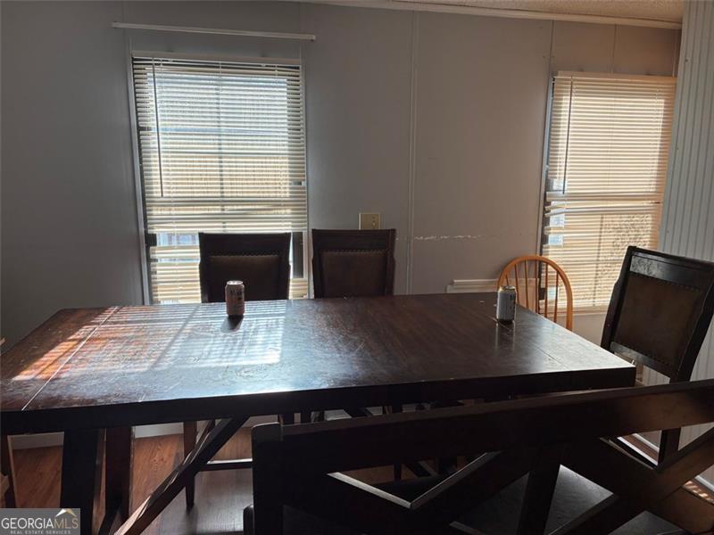 5165 Sycamore Trail, Unit 285 Buford, GA 30518 - Photo 3 of 7 a view of a workspace with a table and chair in the room